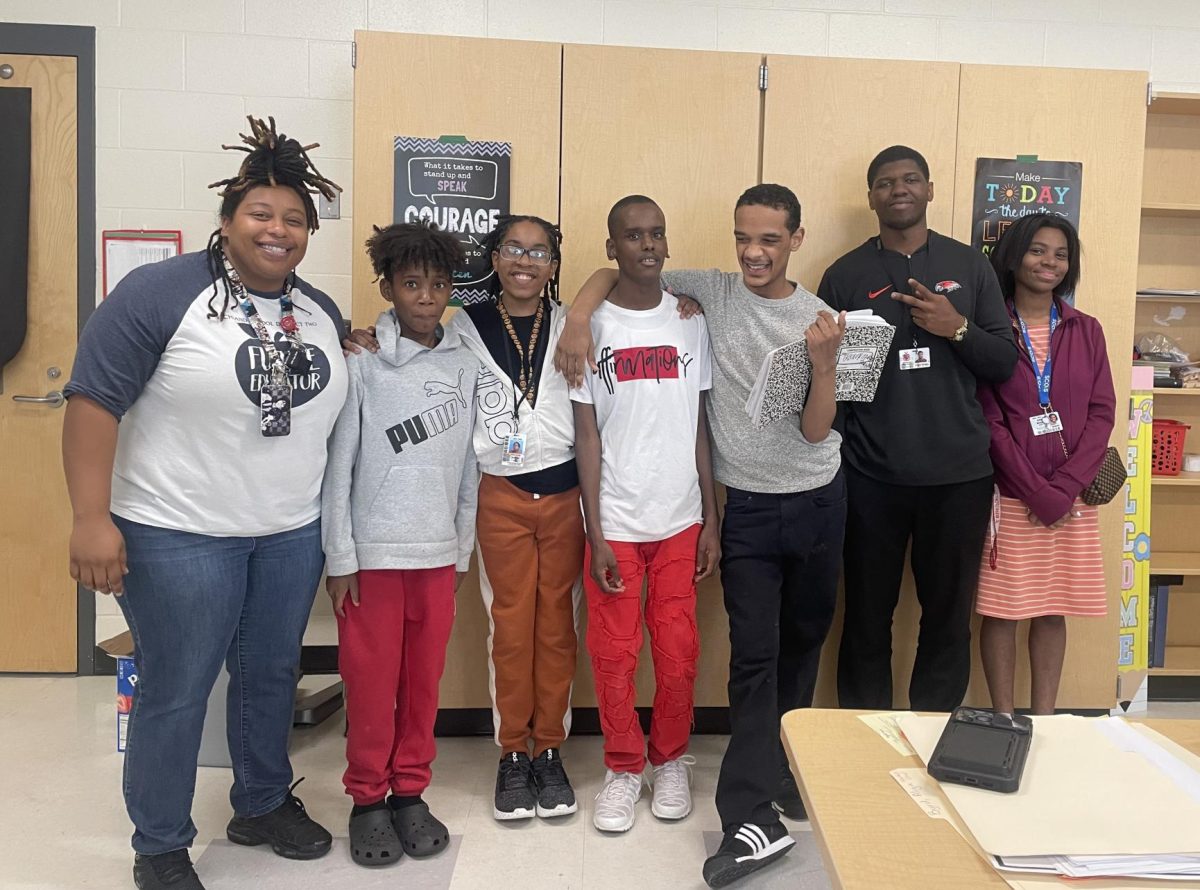 Ms. Bryd and Mr. Flowers (In the Black shirt) with their students in the classroom