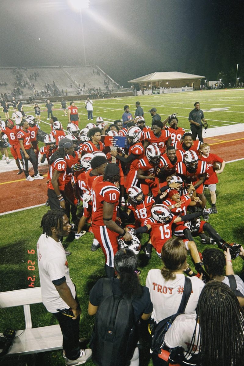 WHS Football Team gathering for a picture with the axe after a win