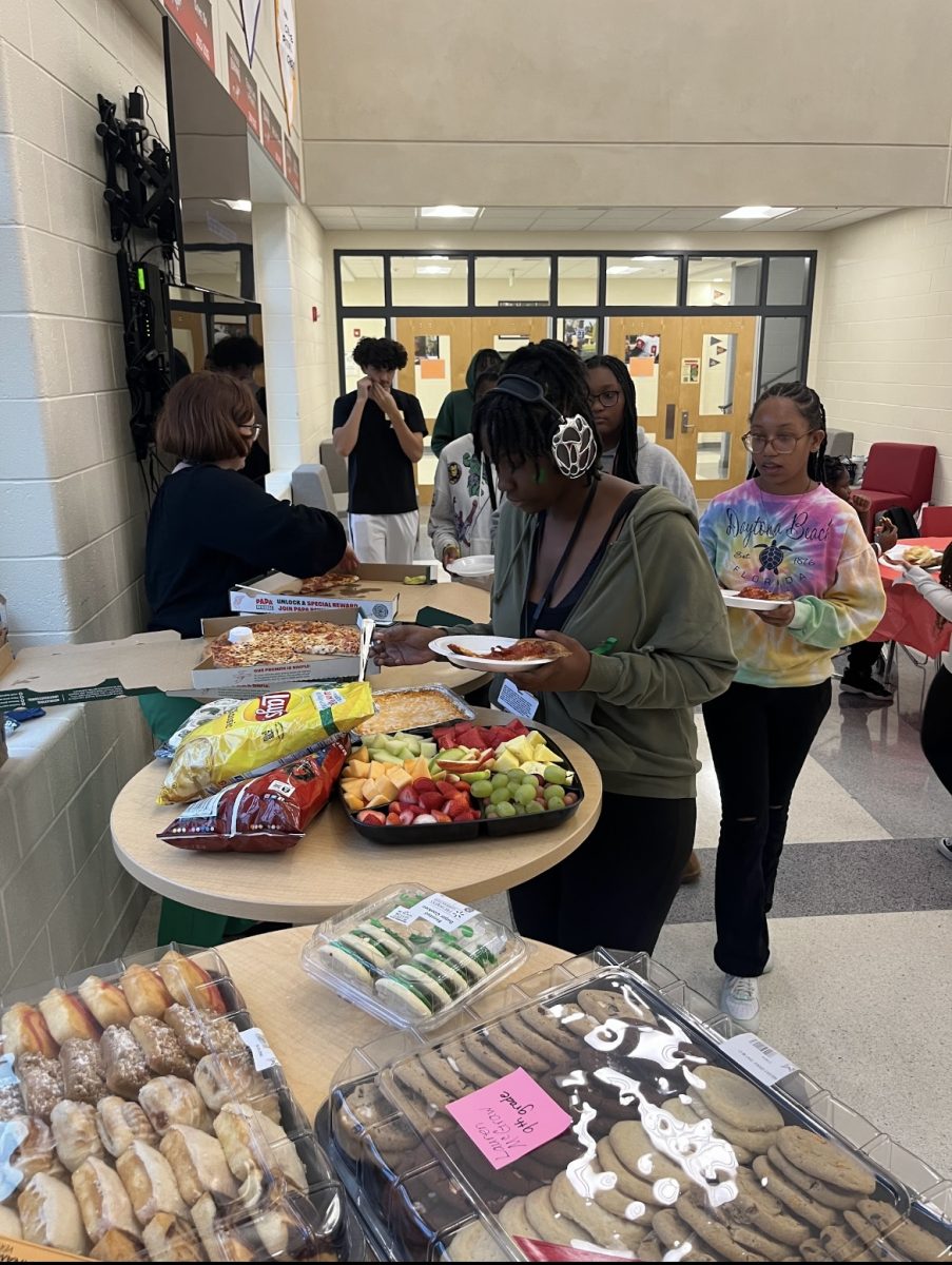 NEHS Thanksgiving Party with a variety of foods including treats displayed in the image.